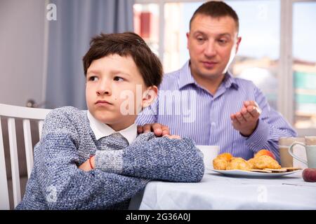 Troubled boy scolded by father Stock Photo