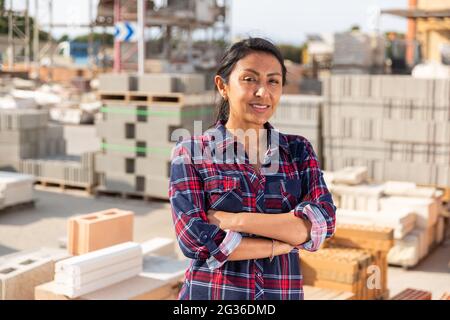 Woman worker posing at building materials warehouse Stock Photo