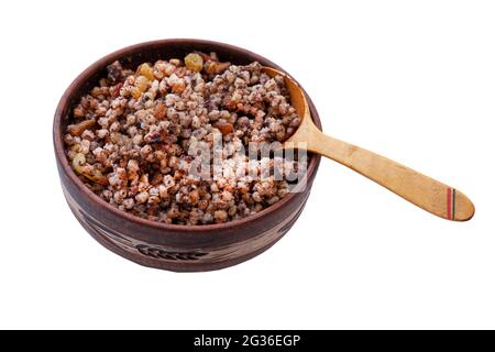 Wheat bowl isolated on white background. Sweet wheat porridge with raisins, poppy seeds and nuts is a traditional Christian Christmas meal. A plate of Stock Photo