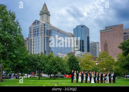 Wedding and Custom House Tower The Financial District from Christopher Columbus Park, Boston, Massachusetts, USA.  Green grass park ground at Christop Stock Photo