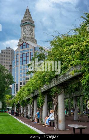 Custom House Tower The Financial District from Christopher Columbus Park, Boston, Massachusetts, USA.  Green grass park ground at Christopher Columbus Stock Photo