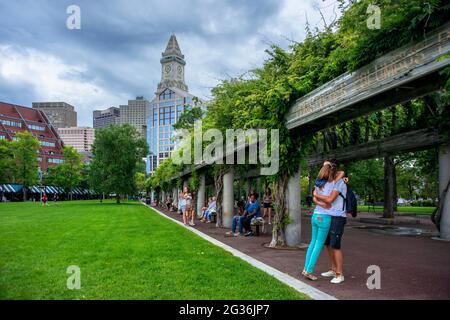 Custom House Tower The Financial District from Christopher Columbus Park, Boston, Massachusetts, USA.  Green grass park ground at Christopher Columbus Stock Photo