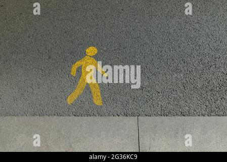 Walk sign on the road Stock Photo