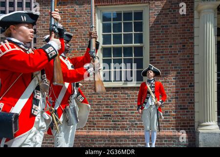 Boston Harborfest Redcoats Soldiers dressed in British Army Uniform reinact a key ceremony parade in front of The Old State House Boston Massachusetts Stock Photo