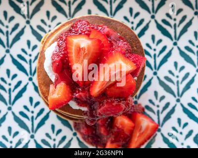 Vegan gluten free banana buckwheat pancakes served with dairy free yogurt and chia strawberry jam Stock Photo