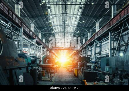 Abstract Industrial interior with light in end of workshop corridor. Metalworking factory. Machine tools for metal processing. Heavy industry concept. Stock Photo