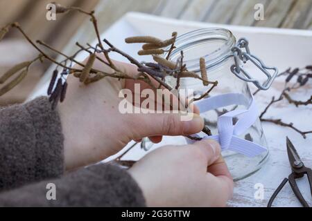lantern, a rubber band is stretched around the glass and twigs are tucked behind the rubber band Stock Photo