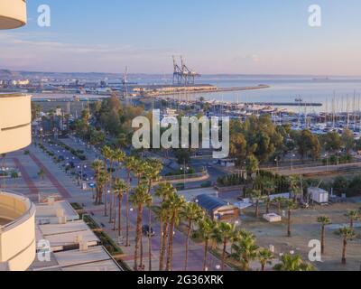 Top aerial view overlooking the Finikoudes palm trees promenade and the port with boats and yachts in the Mediterranean sea of Larnaca old town. Stock Photo