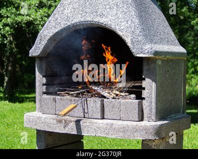 Daytime outdoor stone barbecue preparation Stock Photo