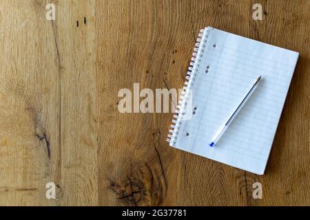 Close up of a blank notebook with a pen on wooden background Stock Photo