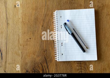 Blank notebook with two pens on wooden background Stock Photo