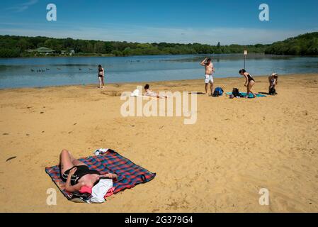London, UK.  14 June 2021.  UK Weather – People sunbathe on the beach at Ruislip Lido in north-west London.  The forecast is for the temperature to rise to 28C, the hottest day of the year so far. Credit: Stephen Chung / Alamy Live News Stock Photo