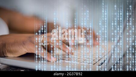 Binary coding data processing against mid section of person using laptop Stock Photo