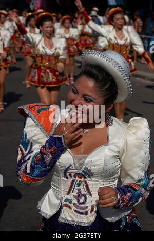 Female members of a Caporales dance group in ornate costumes performing at the annual Carnaval Andino con la Fuerza del Sol in Arica, Chile Stock Photo