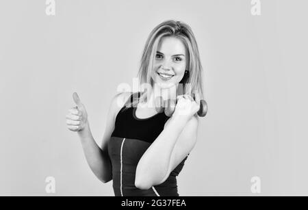 Always in good shape. coach dressed in sport clothes. muscular woman in  training pumping up muscles of hands. girl use barbell blue background.  girl doing triceps exercise with dumbbell in the gym Stock Photo - Alamy