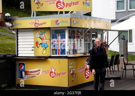 Woman in front of hot dog stand, pedestrian zone, main shopping street, Hafnastraeti, Akureyri, North Iceland, Iceland Stock Photo