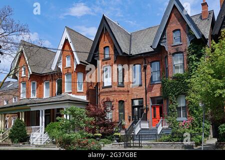 Row of old Victorian semi-detached houses with gables, typical of older neighborhoods in downtown Toronto Stock Photo