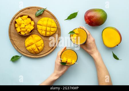 Mango slices and cubes with fresh mango smoothie. Top view Stock Photo