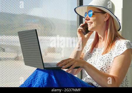 Female freelancer at airport. woman working with laptop in airport until departure. Stock Photo