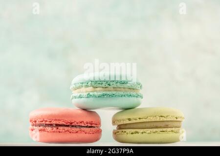 heap of colorful macaroons over a green background with copy space Stock Photo