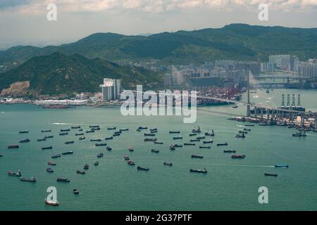 Barges and lighters used for mid-stream transfer of shipping containers to and from ships moored outside Hong Kong's container port ... Stock Photo