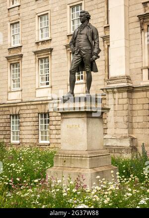 Edmund Burke statue and wildflower meadow at the College Green entrance for the Trinity College in Dublin, Ireland as of June 2021 Stock Photo