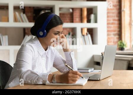 Smiling Indian woman take notes using smartphone Stock Photo - Alamy