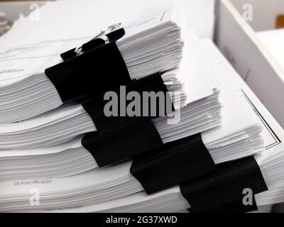 Stacks of documents with black clips in box for filing business legal education Stock Photo