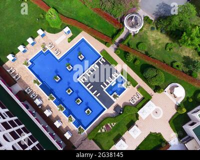 BURGAS, BULGARIA - MAY 15, 2021: Primoretz Grand Hotel and Spa. Aerial view of luxury outdoor swimming pool and deck-chairs. Stock Photo