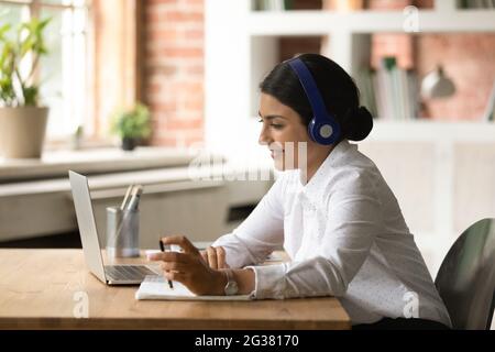 Focused young indian woman studying on online courses. Stock Photo