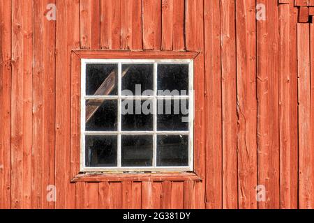 Window on a red weathered barn Stock Photo