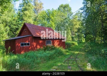 Old red shed at a light railway in the forest Stock Photo