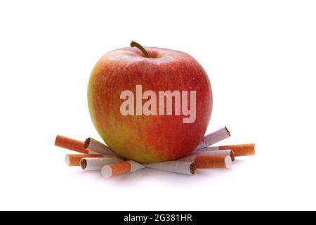 big red apple on smashed cigarettes isolated on white background, stop  smoking concept Stock Photo