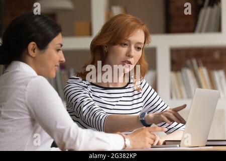 Focused young mixed race employees working on computer. Stock Photo