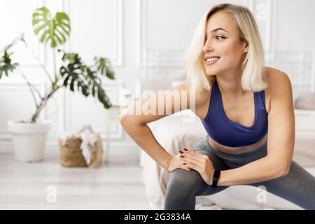 Headshot portrait of beautiful smiling athletic woman doing sports, yoga, pilates or fitness instructor, attractive female trainer in sportswear, gray Stock Photo