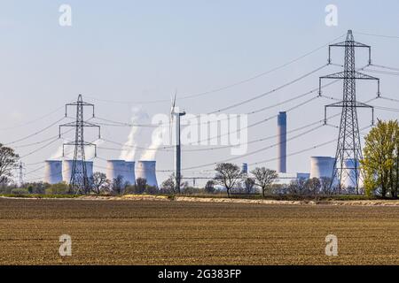 Drax biomass and coal fired power station with pylons and a wind turbine, North Yorkshire UK Stock Photo