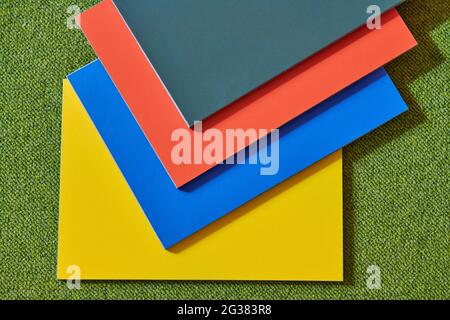 on a green background blue red yellow gray colors for finishing texture tiles Stock Photo