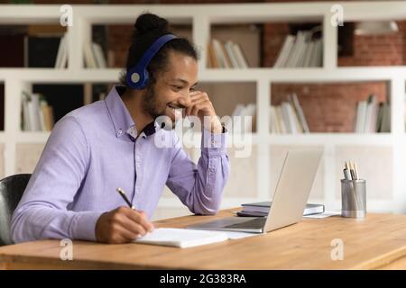 Happy young african american man watching educational lecture. Stock Photo
