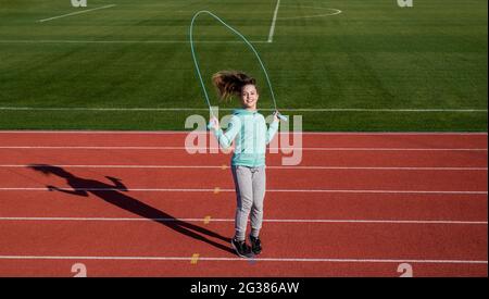 Rope skipping. Energetic child jump over skipping rope. Gymnastics. Fitness and sport Stock Photo