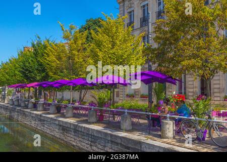 Riverside cafe in the Champagne region town of Troyes, France. Unknown family enjoying a riverside cafe in Troyes France. Stock Photo