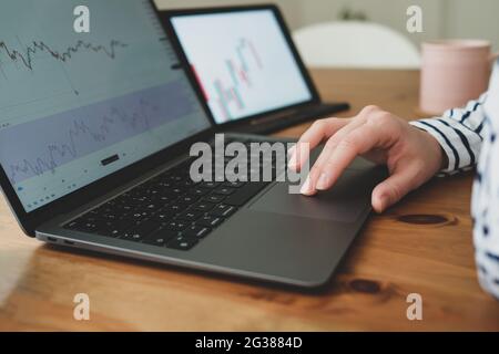 Businesswoman working on laptop using trackpad. Stock Photo