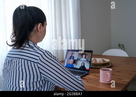 Business woman having a video call with her friends on a web cam at her home. to give distance education from home with a camera. Stock Photo