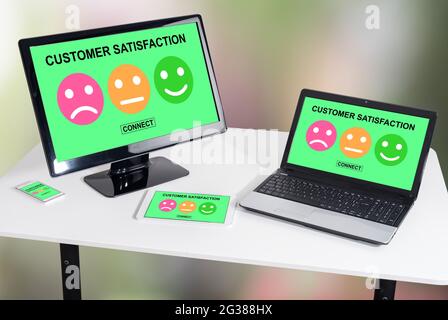 Customer satisfaction concept shown on different information technology devices Stock Photo