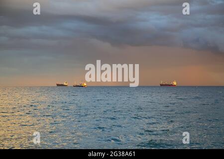 Mediterranean sea, three ships on horizon, heavy swirling clouds in teh sky Stock Photo