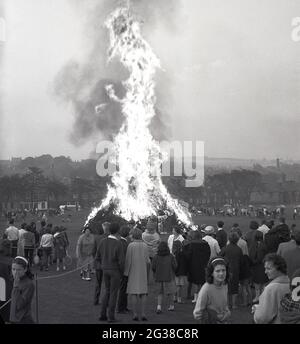 1960s, historical, early evening time at a public park and people watching a large bonfire burning, Fife, Scotland, UK. Stock Photo