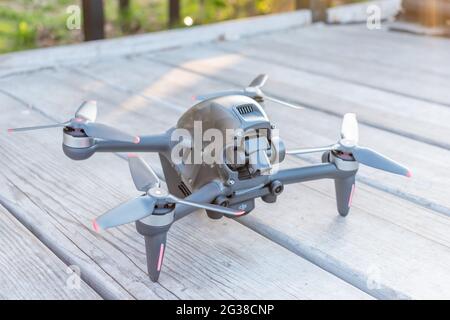 Kiev, Ukraine - April 26, 2021: A new DJI FPV drone on wooden background. Stock Photo