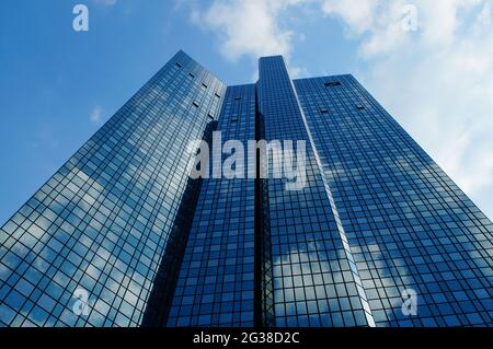 FRANKFURT, GERMANY - Jun 10, 2021: The Deutsche Bank twin towers reflect the blue-white sky and themselves. Also called 'Soll und Haben', means 'Credi Stock Photo