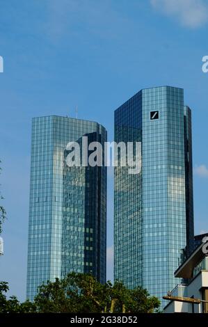 FRANKFURT, GERMANY - Jun 10, 2021: The Deutsche Bank twin towers reflect the blue-white sky and themselves. Also called 'Soll und Haben', means 'Credi Stock Photo
