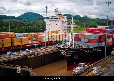 PANAMA CANAL LOCKS ..The Panama Canal locks is a lock system that lifts a ship up 25.9 m (85 ft) to the main elevation of the Panama Canal and down again. It has a total of six steps (three up, three down for a ship's passage). The total length of the lock structures, including the approach walls, is over 3 kilometres (nearly two miles). They are one of the greatest engineering works ever to be undertaken at the time, when they opened in 1914. No other concrete construction of comparable size was undertaken until the Hoover Dam in the 1930s.There are two independent lanes of transition (each l Stock Photo