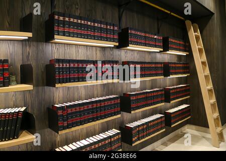 JOHANNESBUR, SOUTH AFRICA - Jun 28, 2019: law books on illuminated shelves with ladder and wood Stock Photo